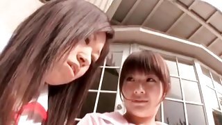 Cute Asians fool around outdoors